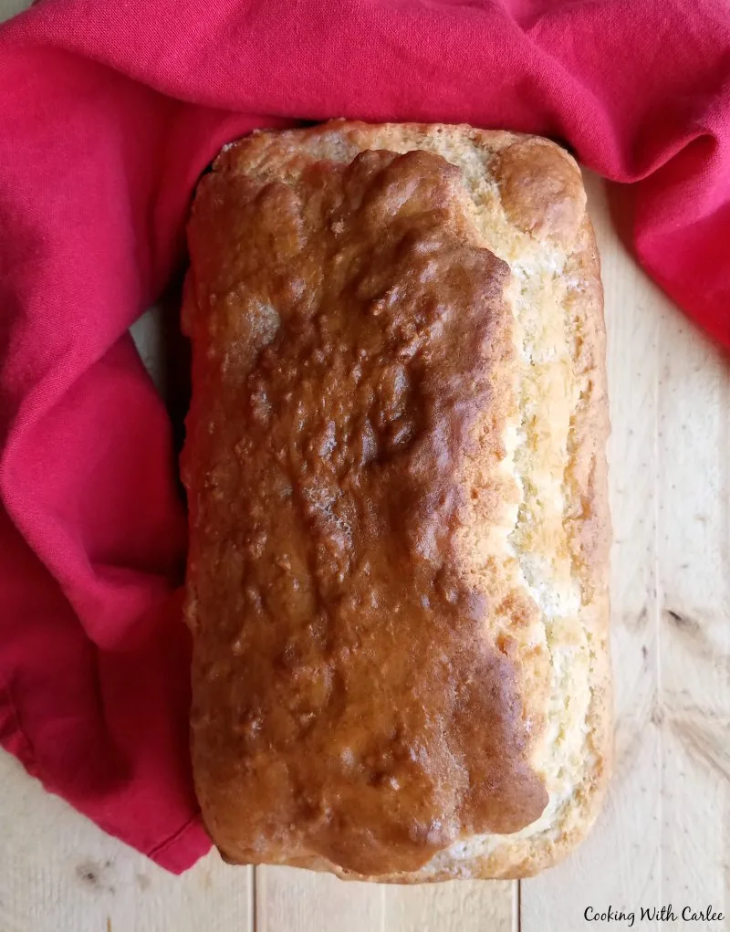golden brown loaf of beer bread ready to be sliced.