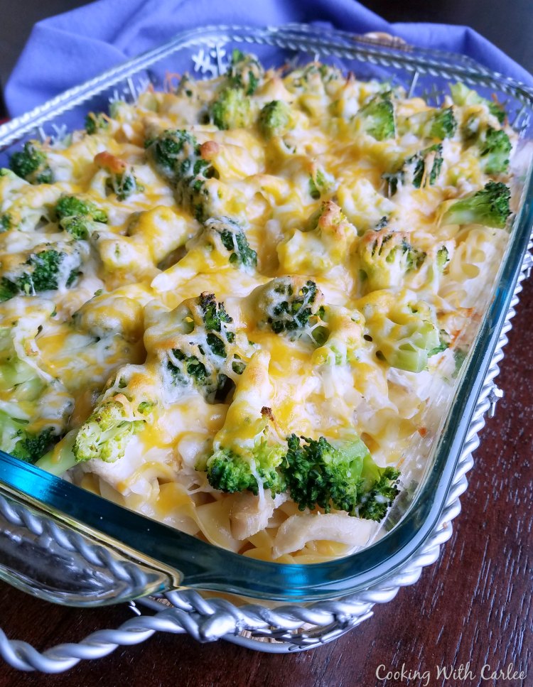 casserole dish filled with egg noodles, broccoli, cheese and chicken baked into a delicious casserole