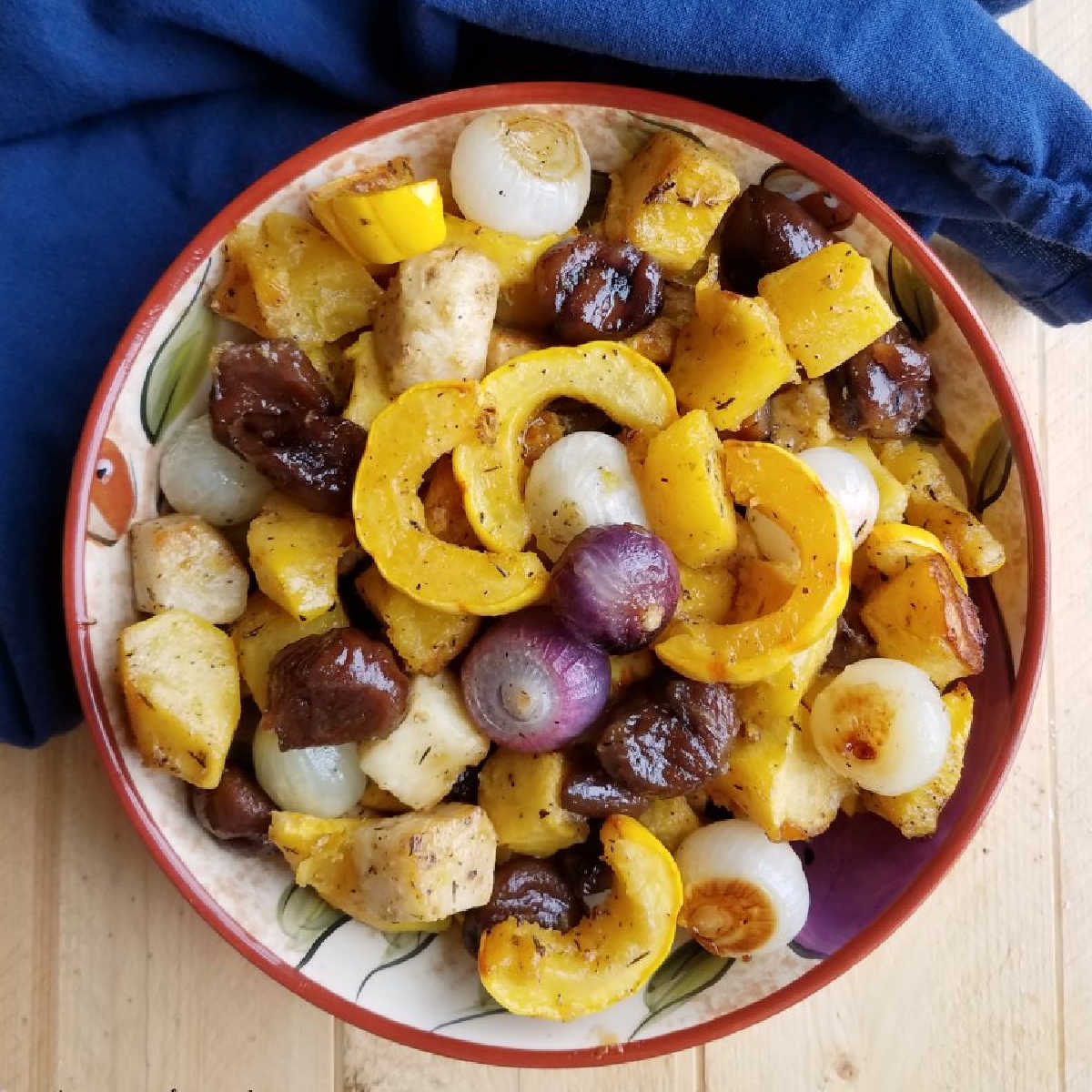 bowl of roasted fall vegetables with chestnuts in a maple glaze ready to serve.