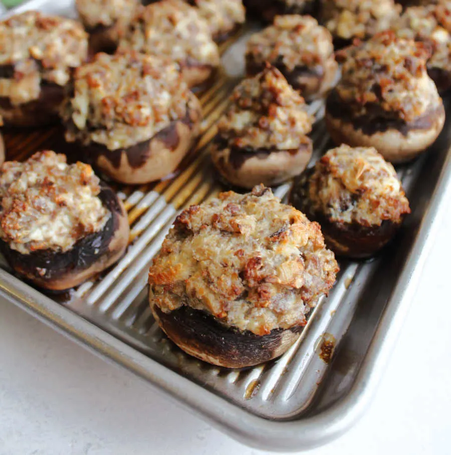 Cooked stuffed mushrooms with golden brown tops fresh from the oven.