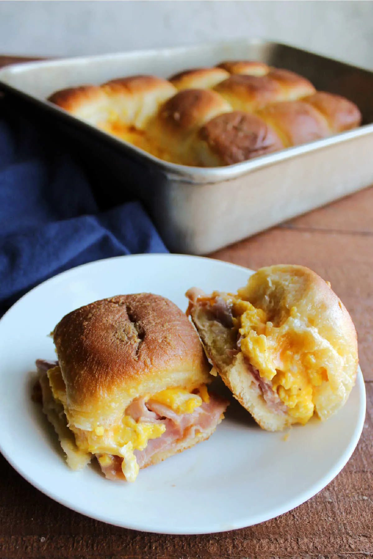 Ham, egg and cheese breakfast sliders on plate, ready to eat. 