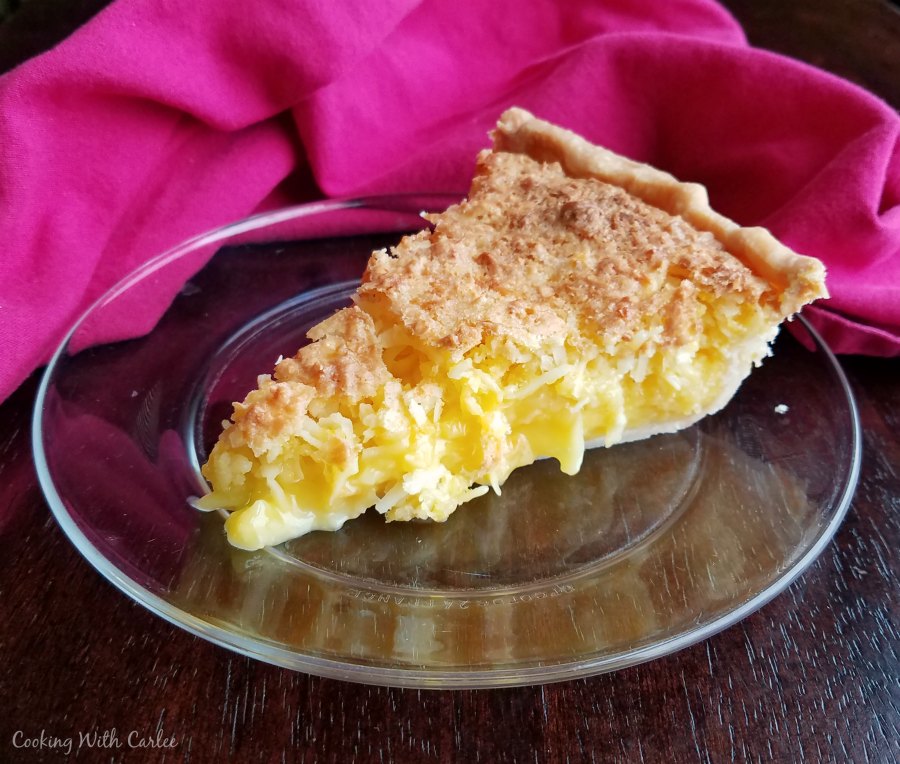 slice of coconut and pineapple pie with yellow filling.