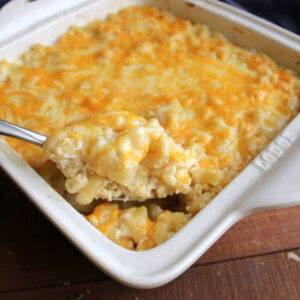 Large serving spoon filled with cheesy baked no boil mac and cheese fresh from the oven.