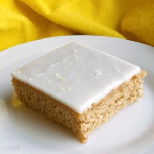 Sweet tea sheet cake topped with lemon icing for an Arnold Palmer cake.