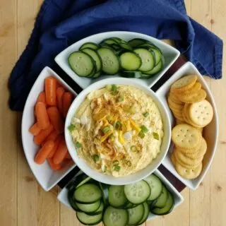 bird's eye view of big serving dish with dip, veggies and crackers.