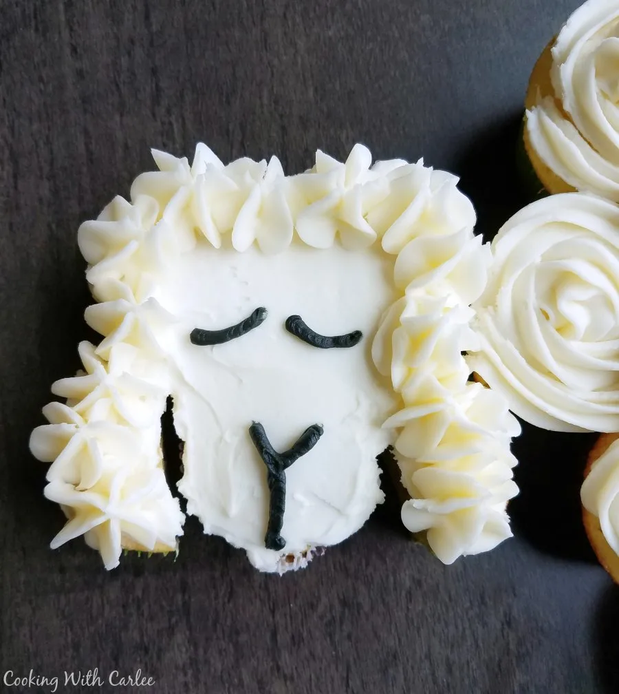 Close up of lamb face on cupcake cake.