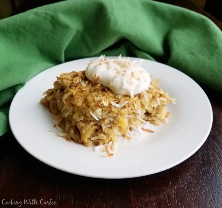 piece of pineapple and coconut baked oatmeal topped with yogurt.