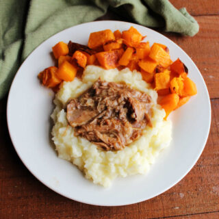 Slow cooked apple cider pulled pork served on mashed potatoes with a side of roasted butternut squash.