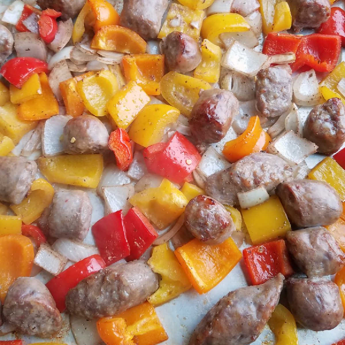 bits of browned Italian sausage and roasted onions and peppers on a sheet pan fresh from the oven.