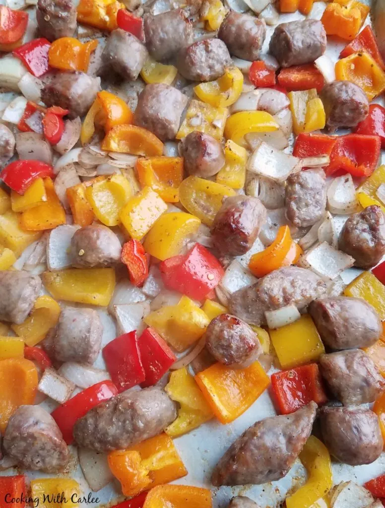 sheet pan loaded with italian sausage, colorful peppers and onions fresh from the oven.