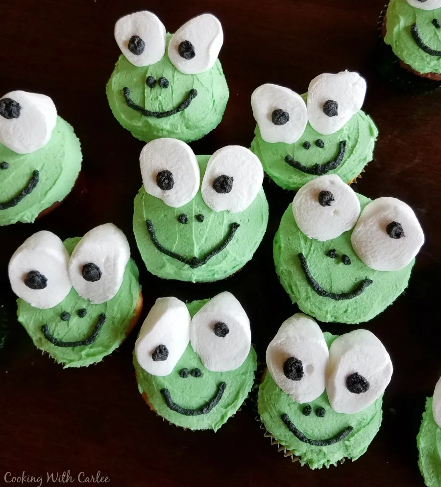 Cupcakes decorated like frogs with marshmallow eyes. 