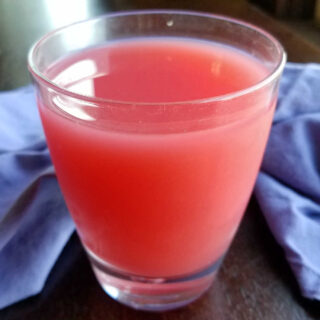 Glass of pink sherbet punch, ready to drink.