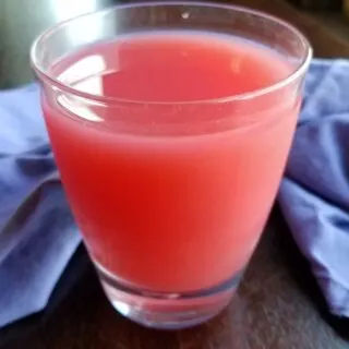 glass of pink sherbet punch, ready to drink.