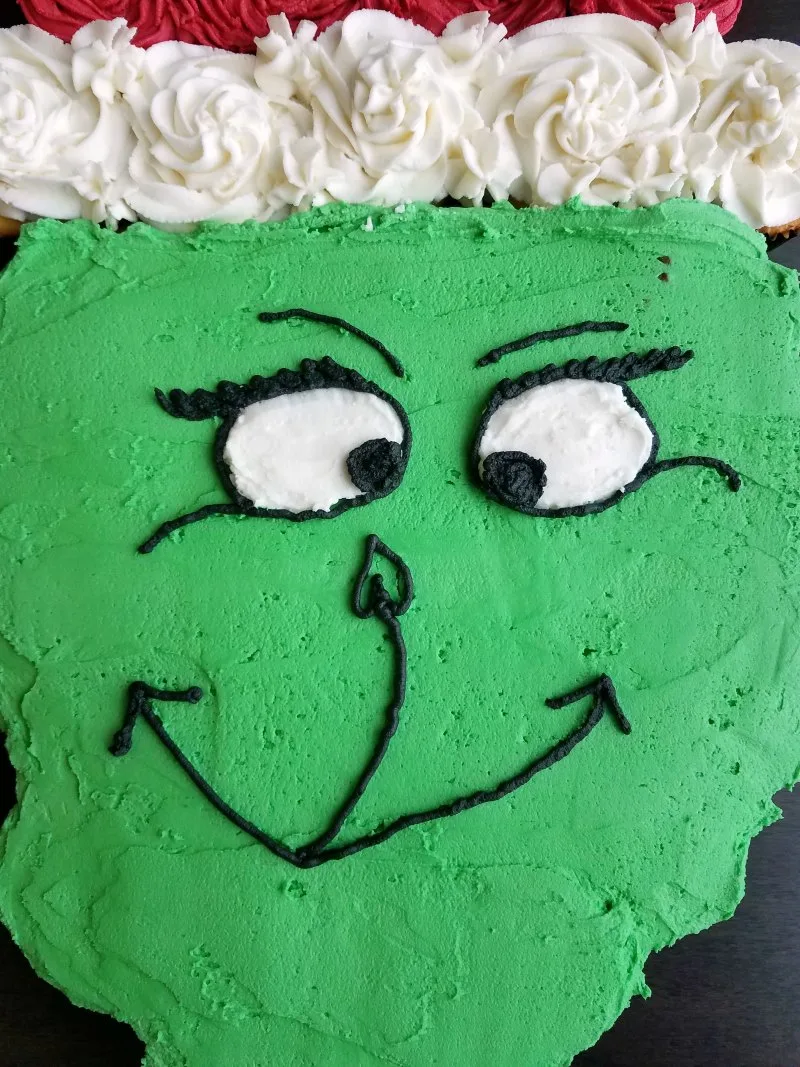 Close Grinch face on cupcake cake.