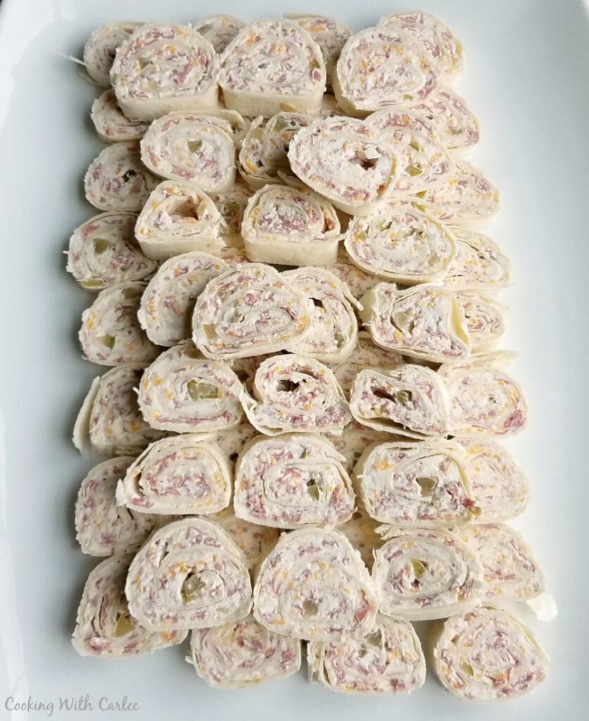 platter filled with bite sized beef, pickle and ranch pinwheels.