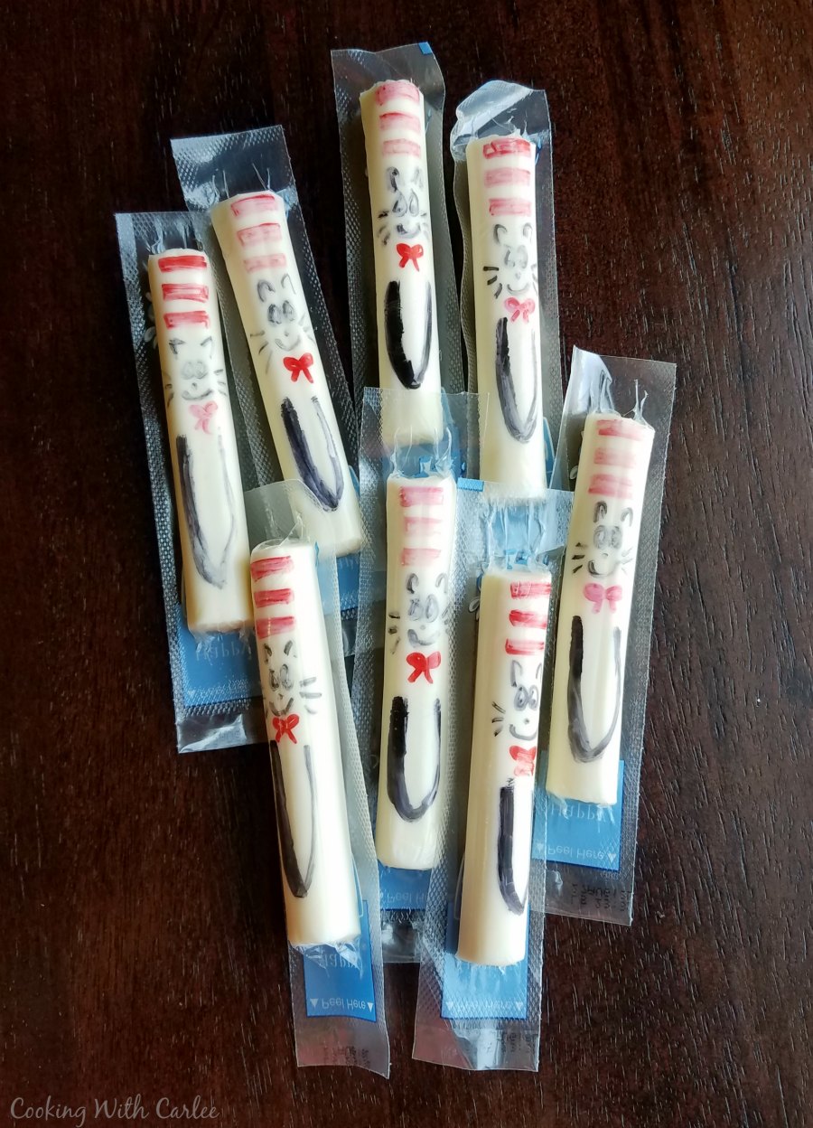 String cheese sticks with cat in the hat drawn on the packages with sharpie.