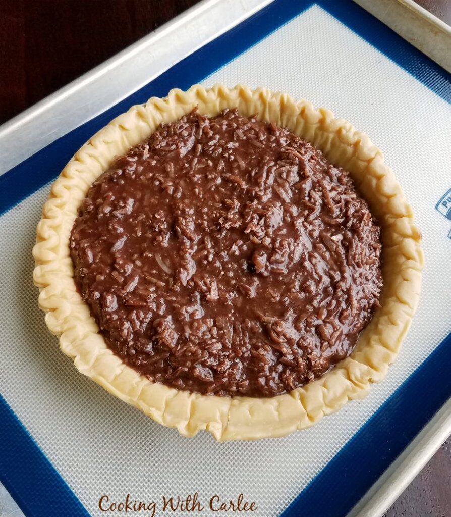 chocolate coconut batter in pie crust ready to bake.