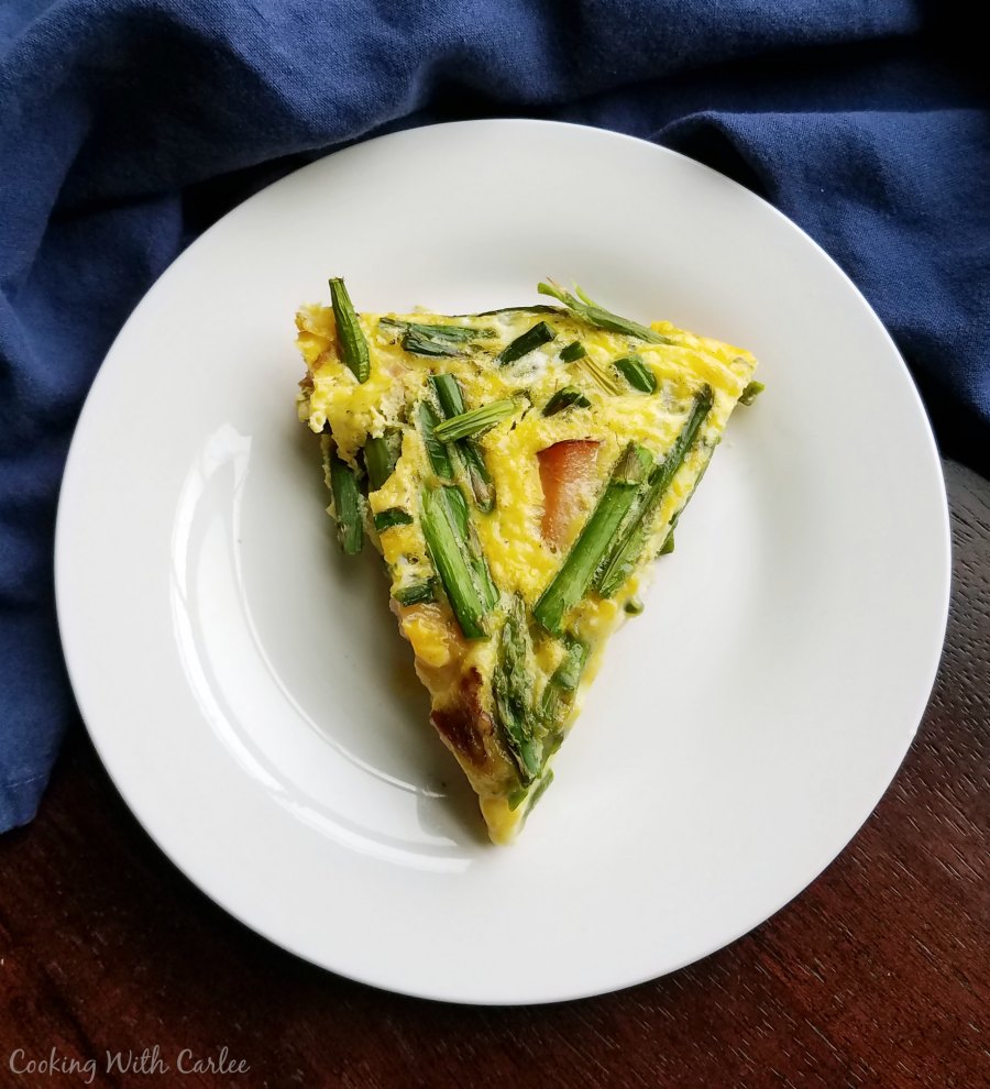 large slice of frittata on white plate.