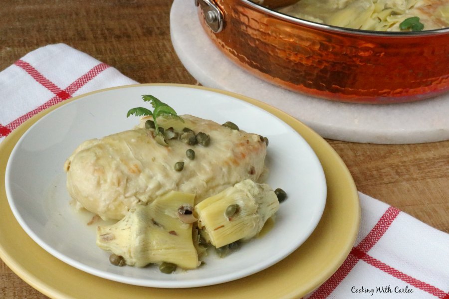 chicken breast and artichokes on plate with capers