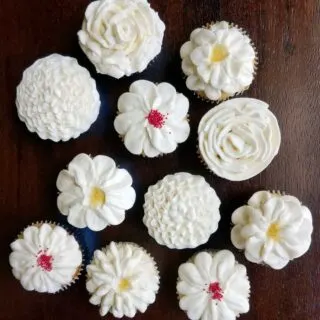 cupcake topped with various piped buttercream flower designs.