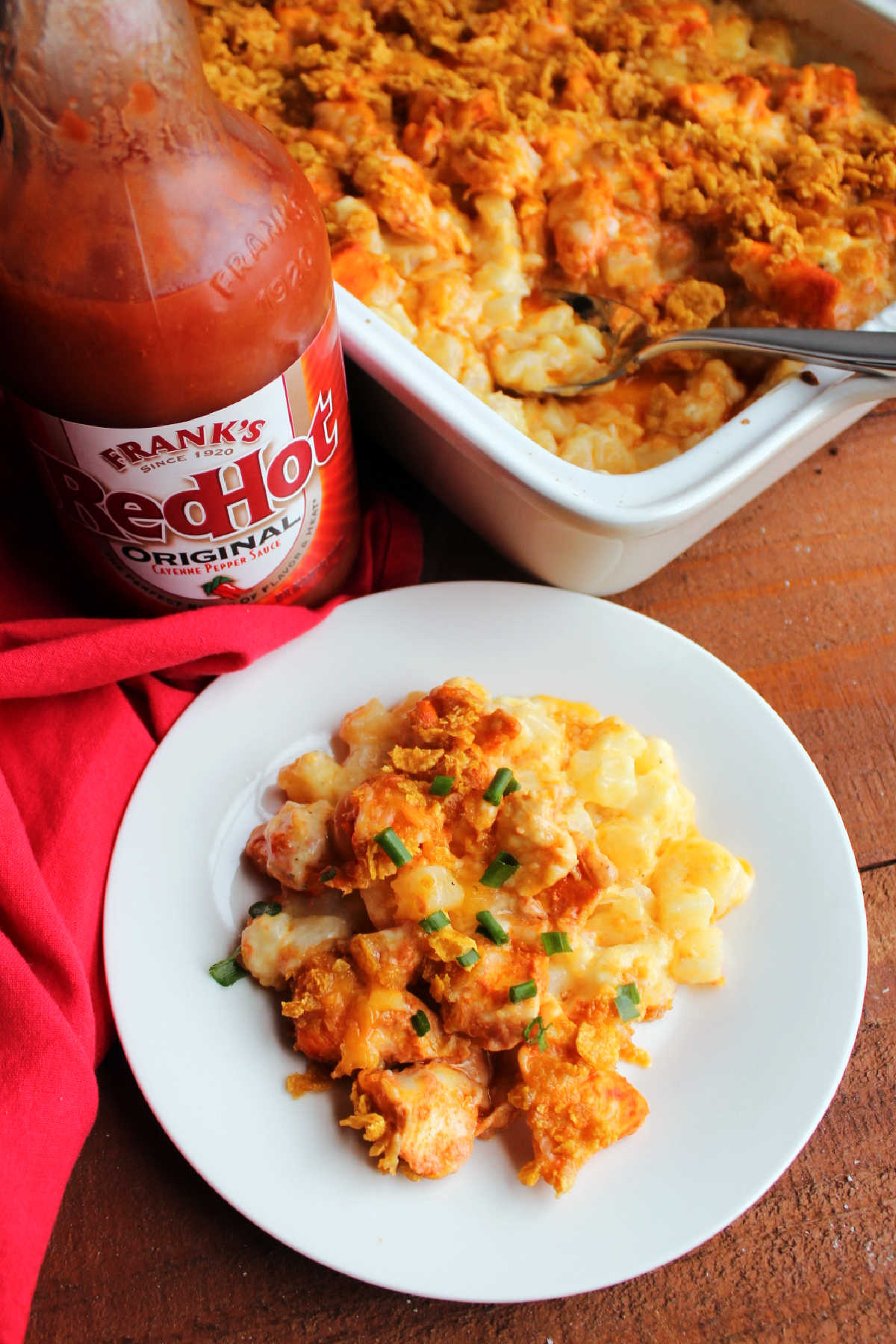 Ranch potato and buffalo chicken bake with bottle of frank's red hot sauce. 
