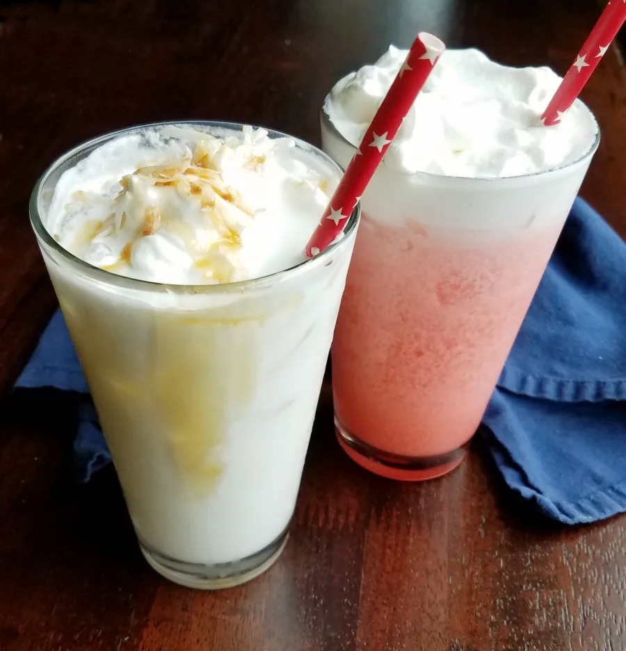 Two classes with Italian soda, one pin and one mostly white topped with whipped cream and toasted coconut.