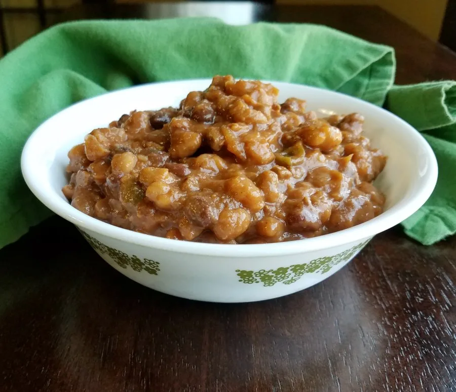 Bowl of cowboy beans with thick and rich baked beans loaded with ground beef and goodies.
