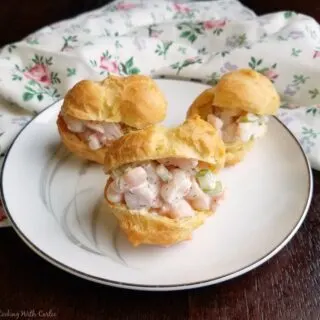 small plate filled with shrimp salad puffs ready to eat.