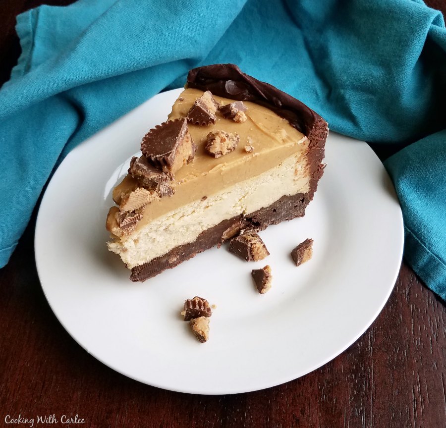 Layers of chocolate crust, creamy peanut butter cheesecake and rich peanut butter topping with chopped peanut butter cups on top.