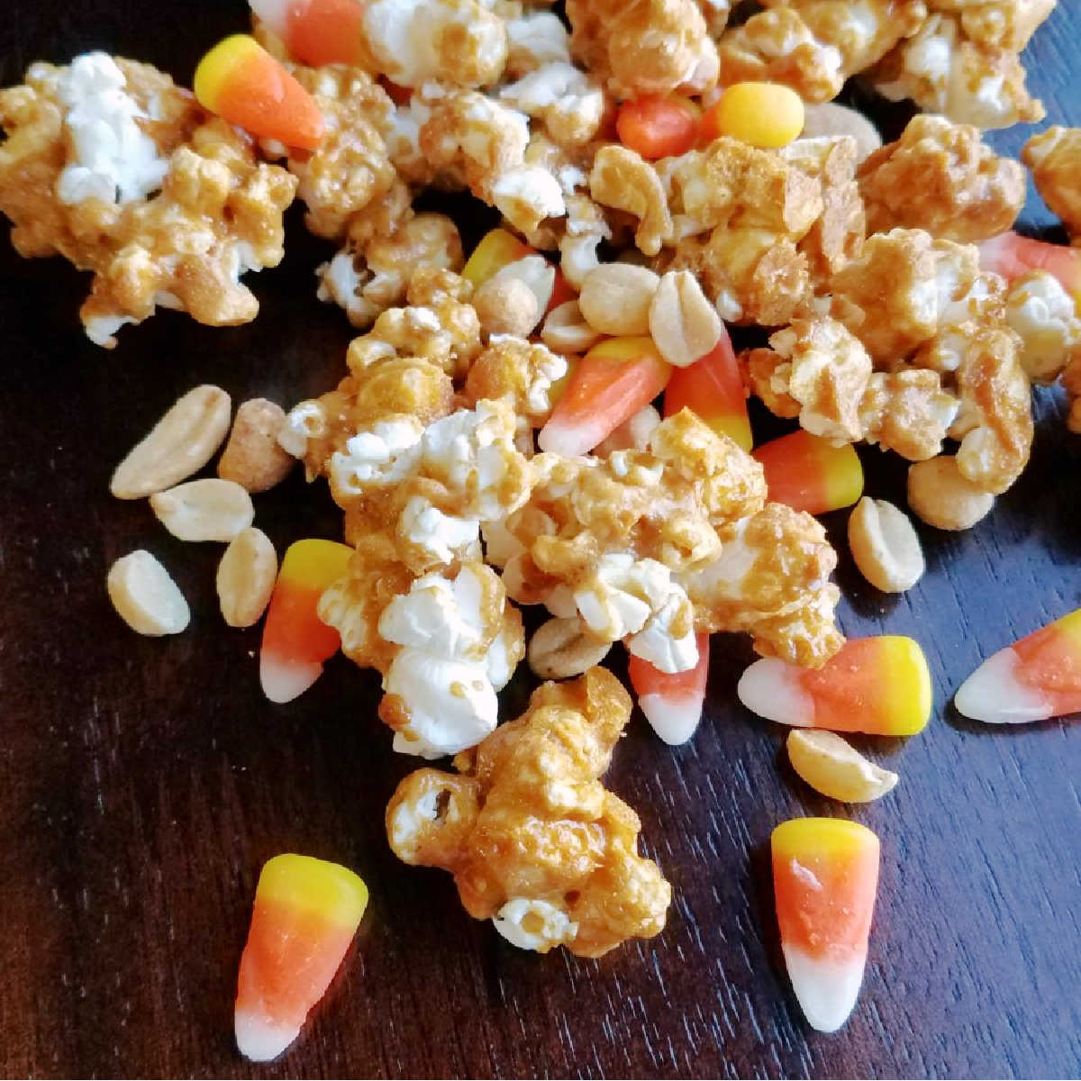 Crunchy peanut butter popcorn mixed with peanuts and candy corn for a fun hillbilly hash snack mix.