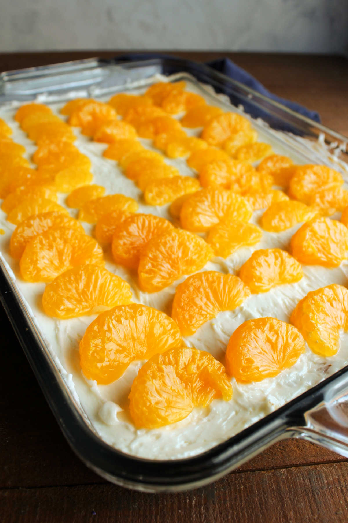 Cream cheese mixture spread all the way to the edges of the pan and topped with drained mandarin oranges. 