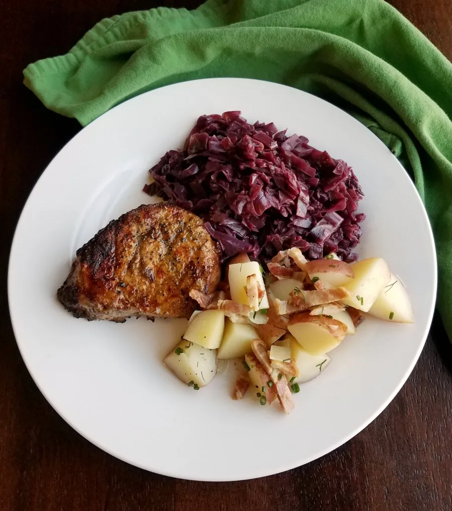 dinner plate with braised cabbage pork loin and german potato salad