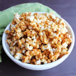 Serving bowl filled with peanut butter caramel popcorn ready to eat.