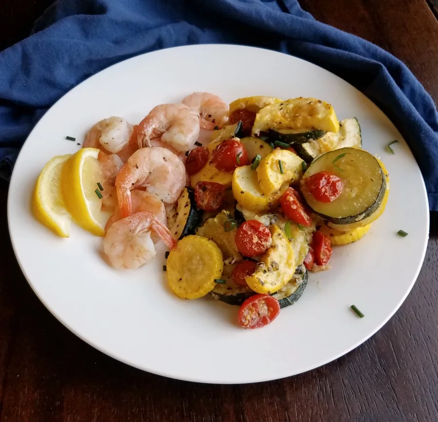 parmesan roasted zucchini and tomatoes served with roasted shrimp.