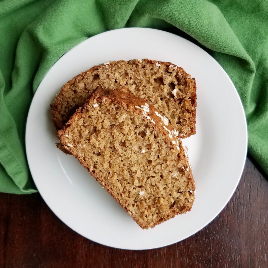 slices of applesauce oatmeal quick bread on plate.