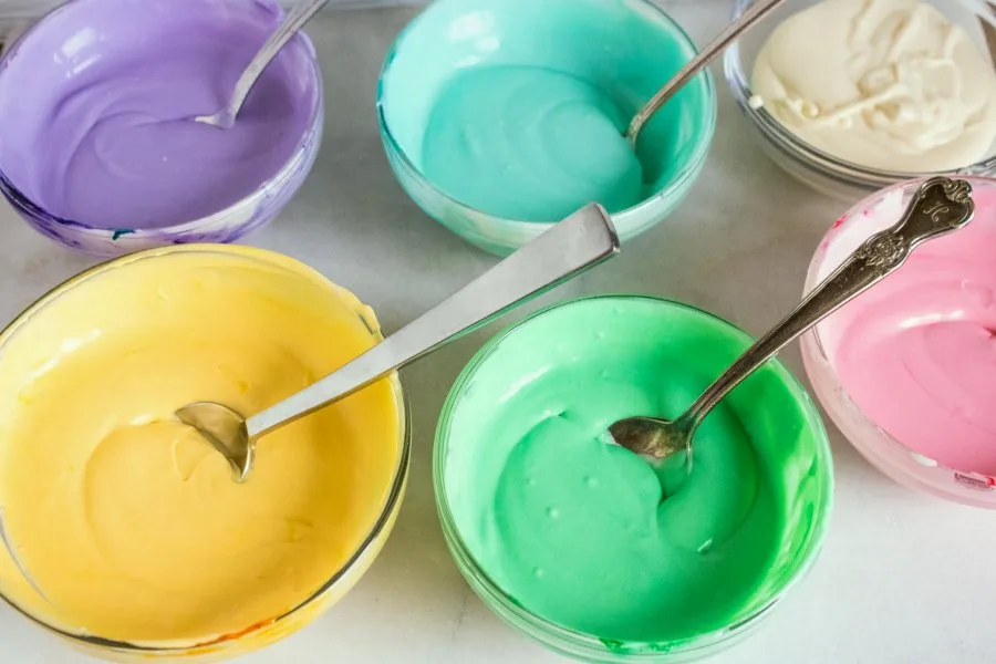 small bowls of various colors of ice cream base.