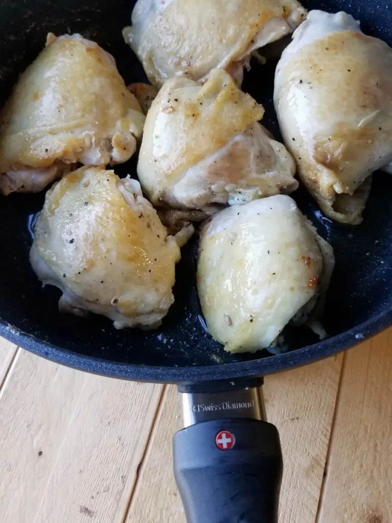 browned chicken thighs in skillet. 