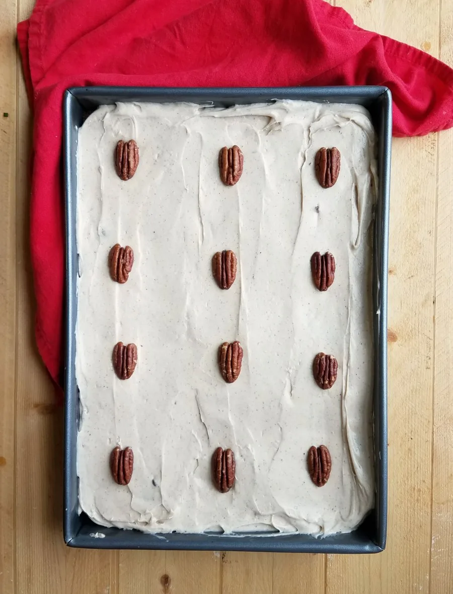 9x13" pan with frosted cake garnished with 12 pecan halves, 1 for each piece