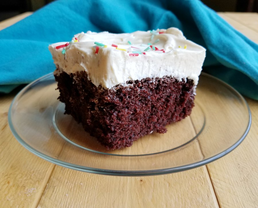 piece of chocolate cake with fluffy sweetened condensed milk frosting on top.