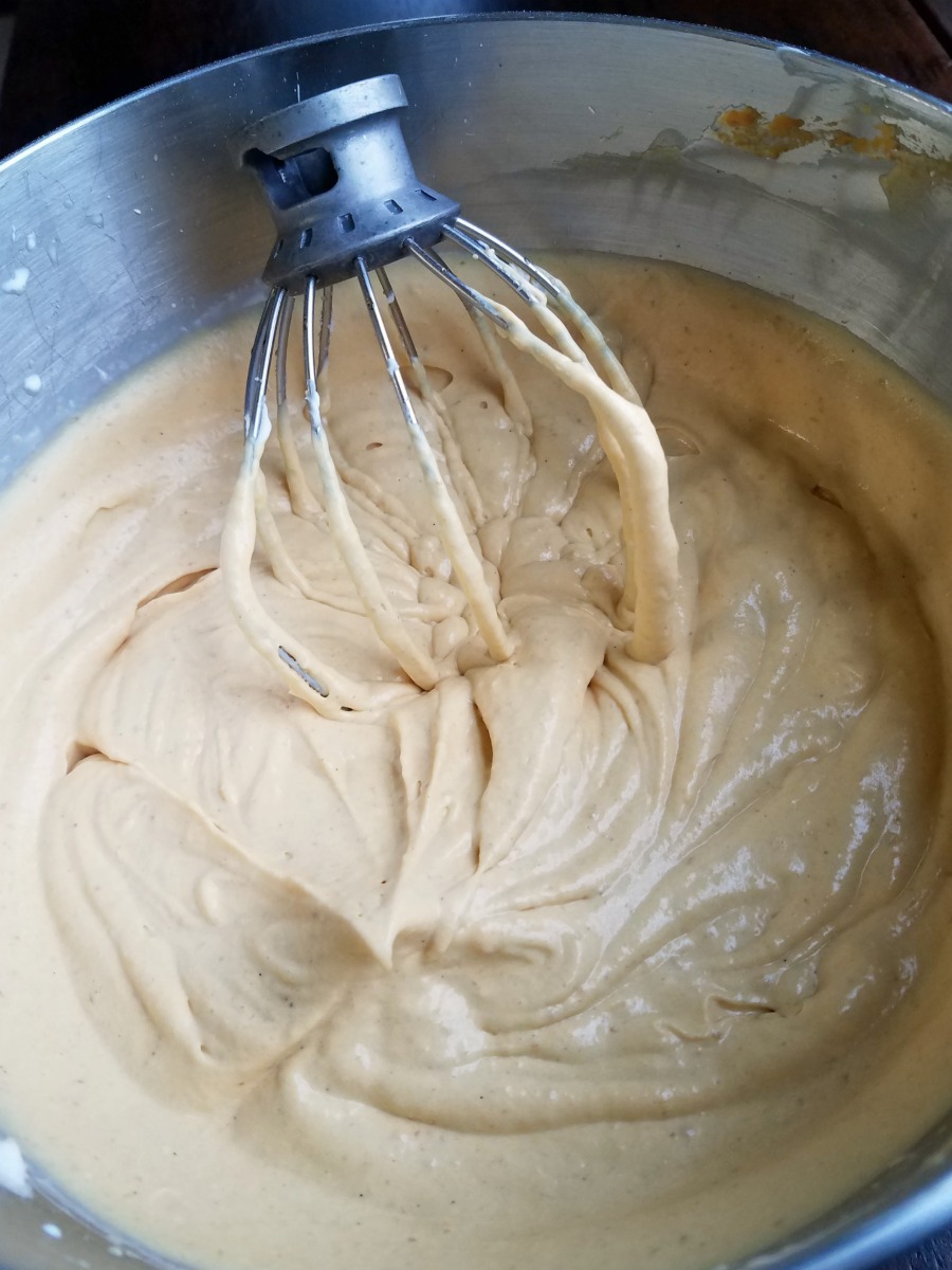 Mixer filled with fluffy pumpkin cream cheese filling.