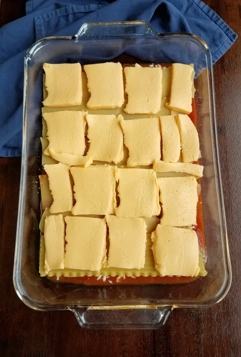 lasagna noodles with slices of Velveeta cheese on them, middle layer of lasagna