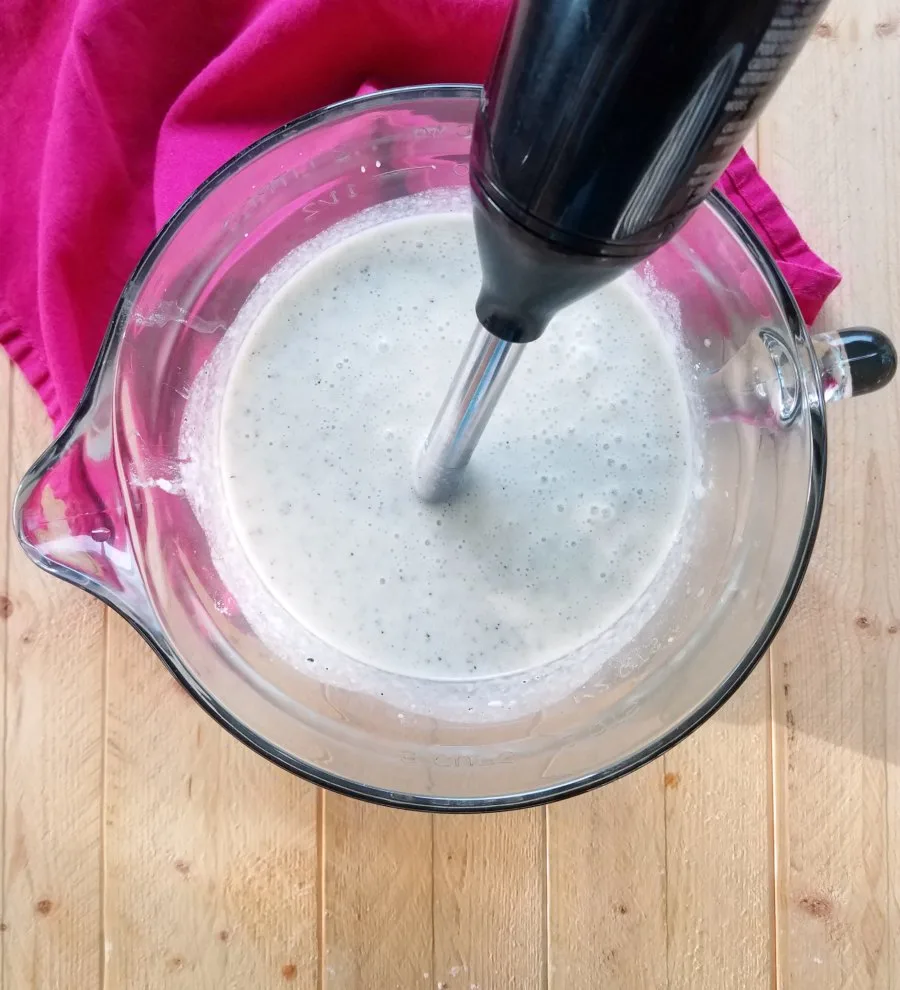 using immersion blender to puree pie batter.