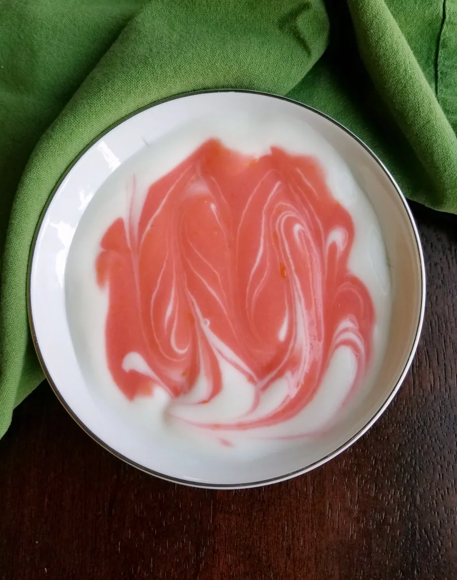 white yogurt with pink blood orange swirl.