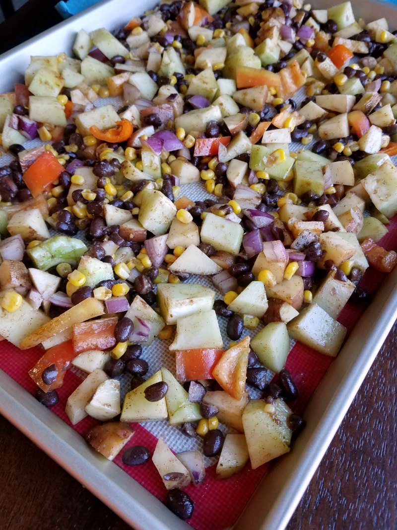 sheet pan filled with diced veggies and black beans.