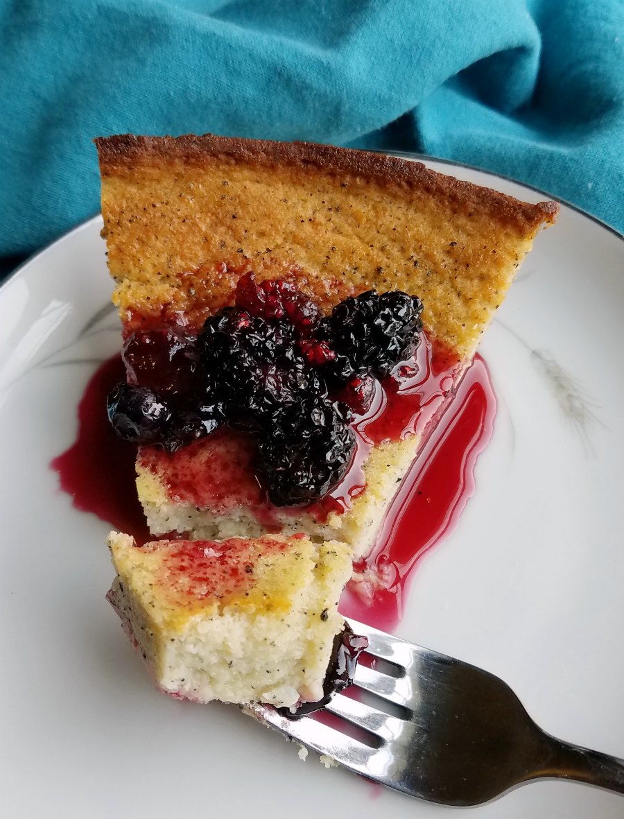 Bite of creamy dragon fruit pie with blackberry sauce on fork ready to eat.