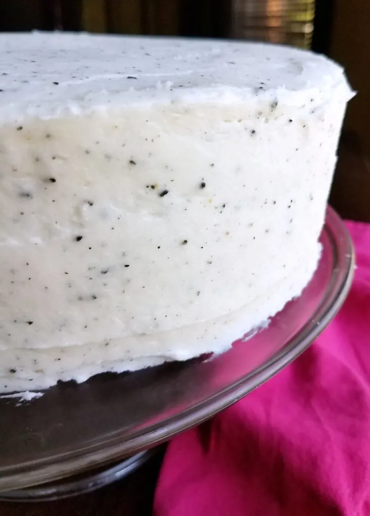 White dragronfruit frosting with black speckles from the seeds on a layer cake.