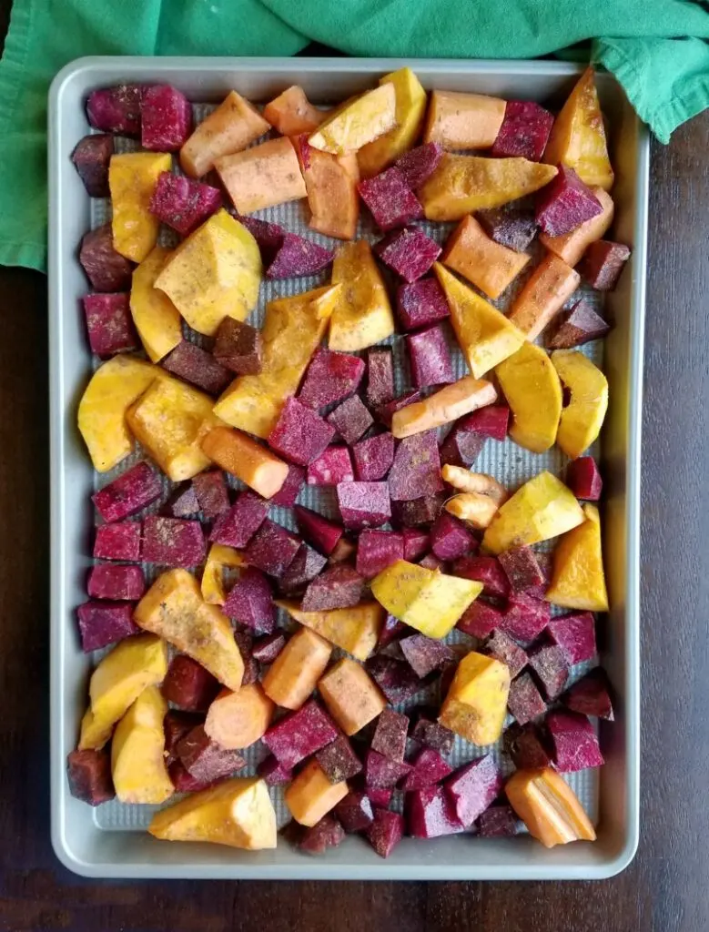 pan of squash and root veggies tossed in chinese 5 spice ready to roast. 