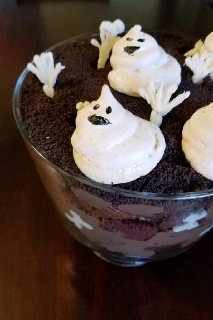 white chocolate bones piped on the inside of a glass trifle bowl.