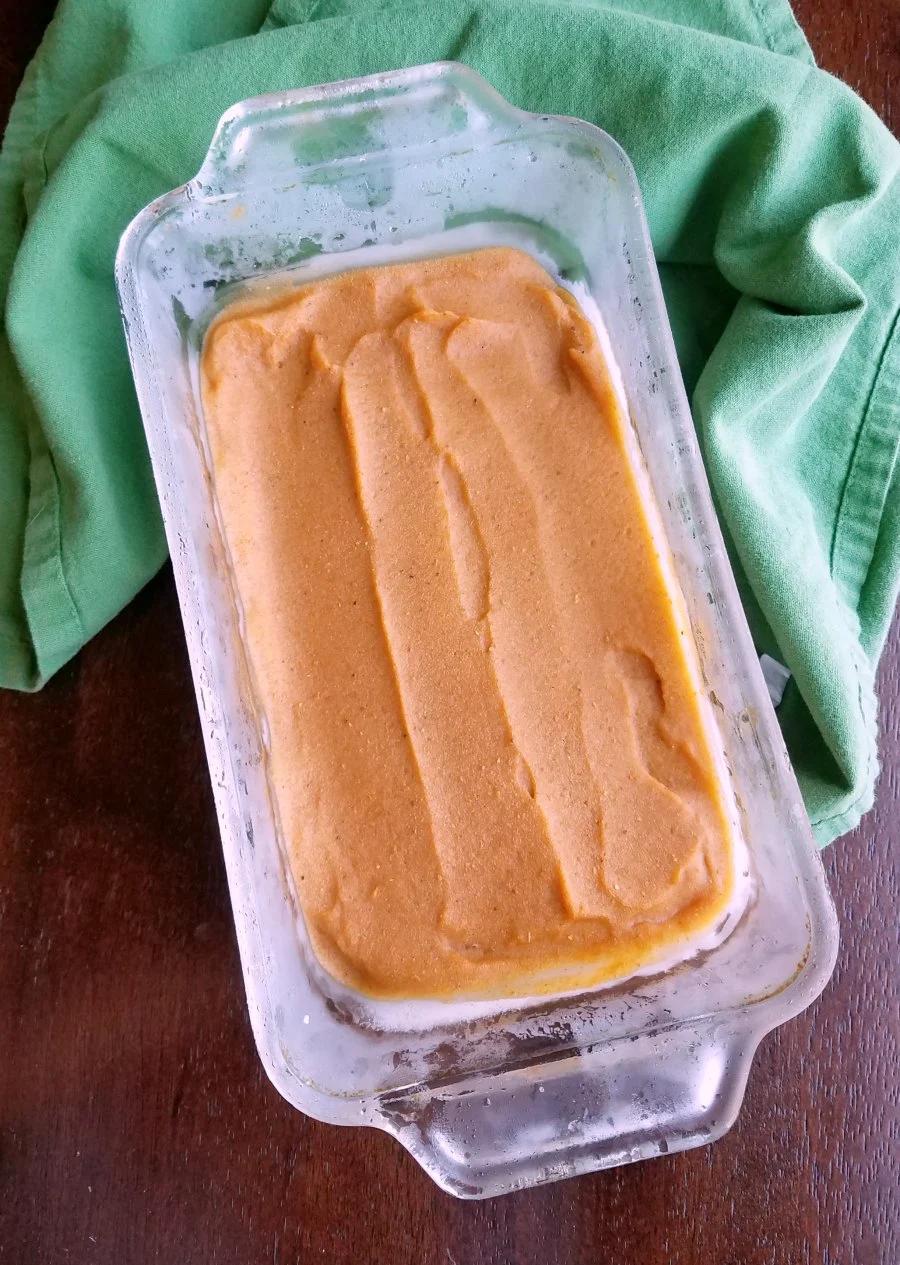 pumpkin nice cream smoothed out in glass loaf pan.