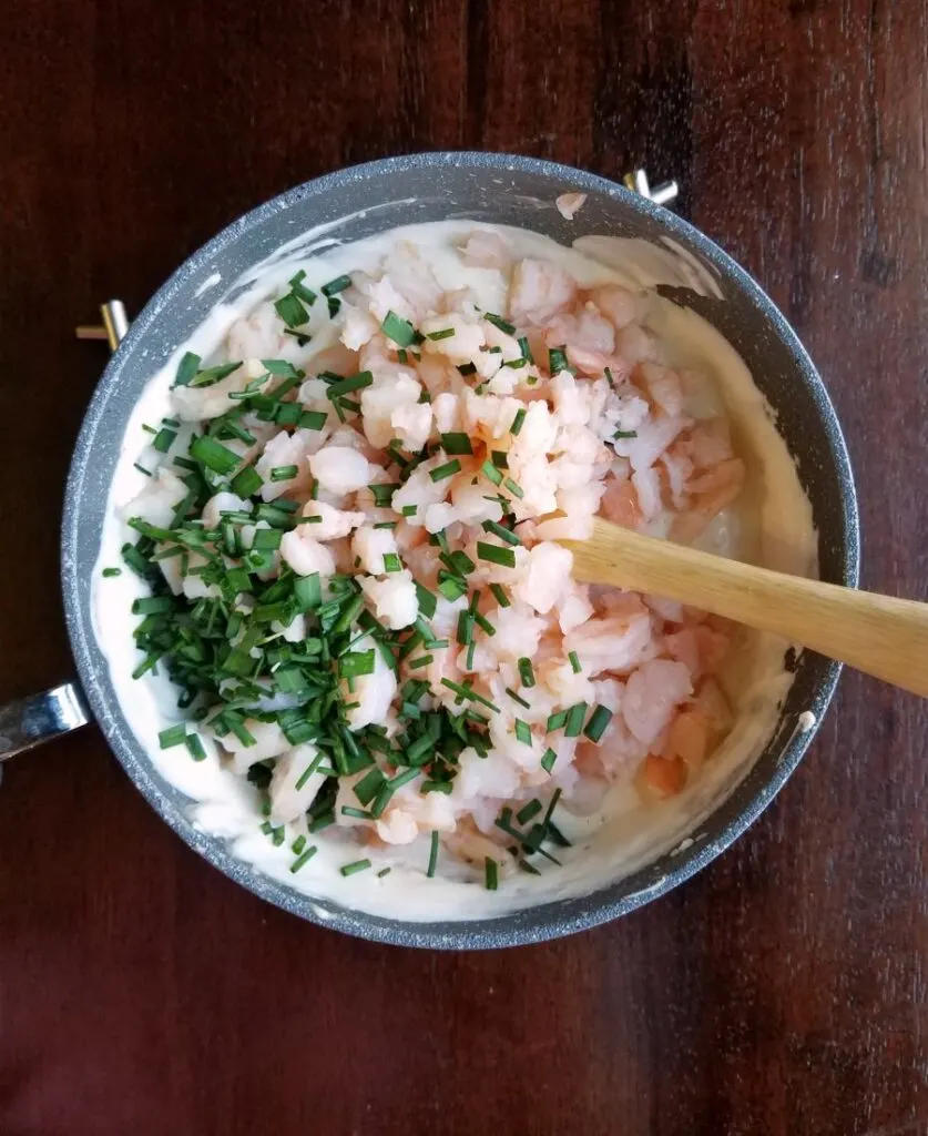 saucepan with cream mixture, shrimp and chopped chives.